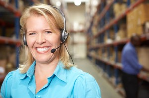 Woman with headset in distribution warehouse