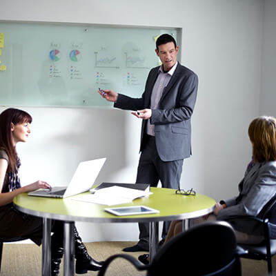 businessman presenting data to other businesspeople in a meeting room